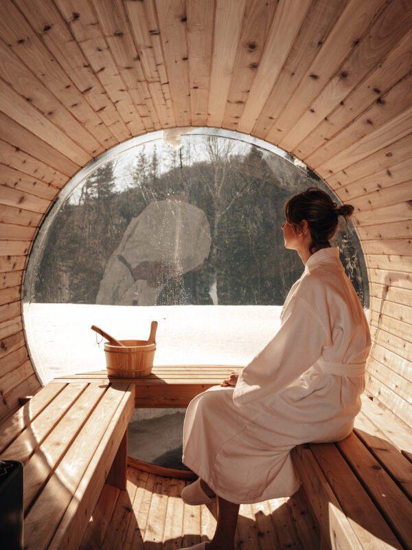 Sauna with a round window onto the forest