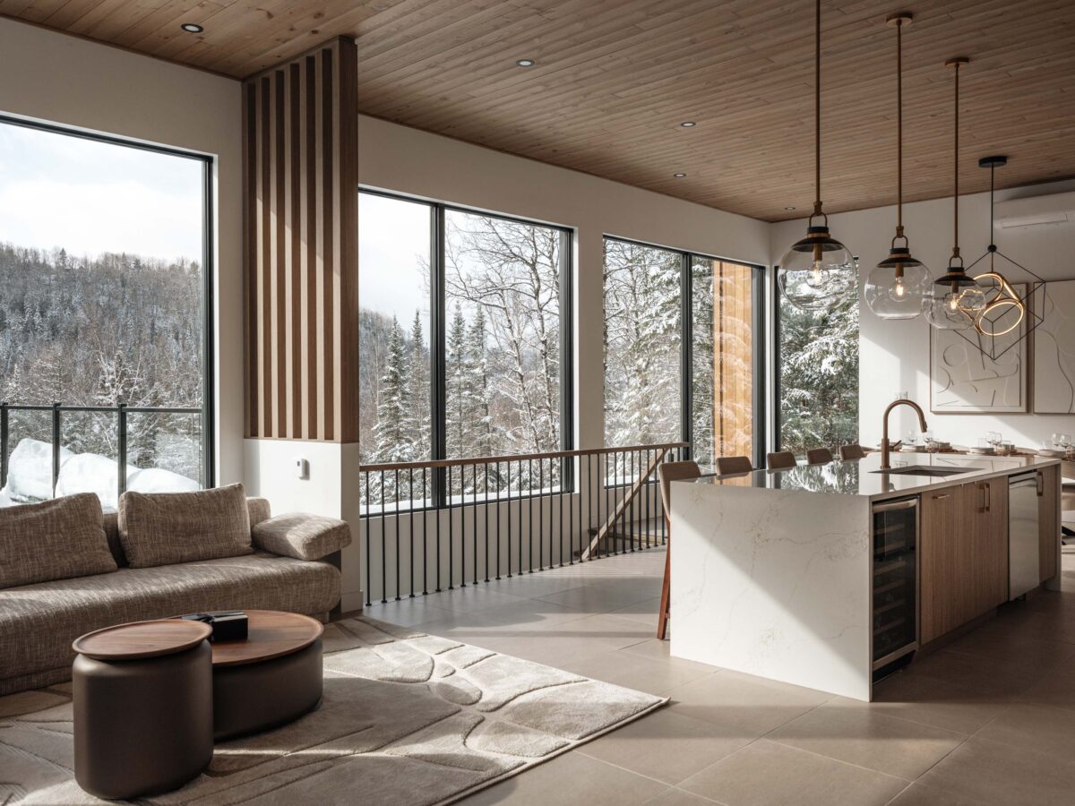 Open living area with fireplace and picture windows